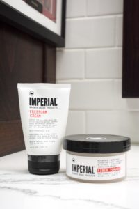 a set of barbershop styling products on a marble countertop