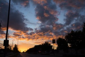 a glowing sunrise illuminates the clouds just over the horizon