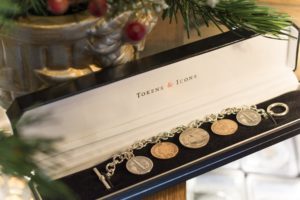 a bracelet of coins on display during a holiday promotion