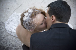 a view from above a couple kissing on the stone steps of the state house